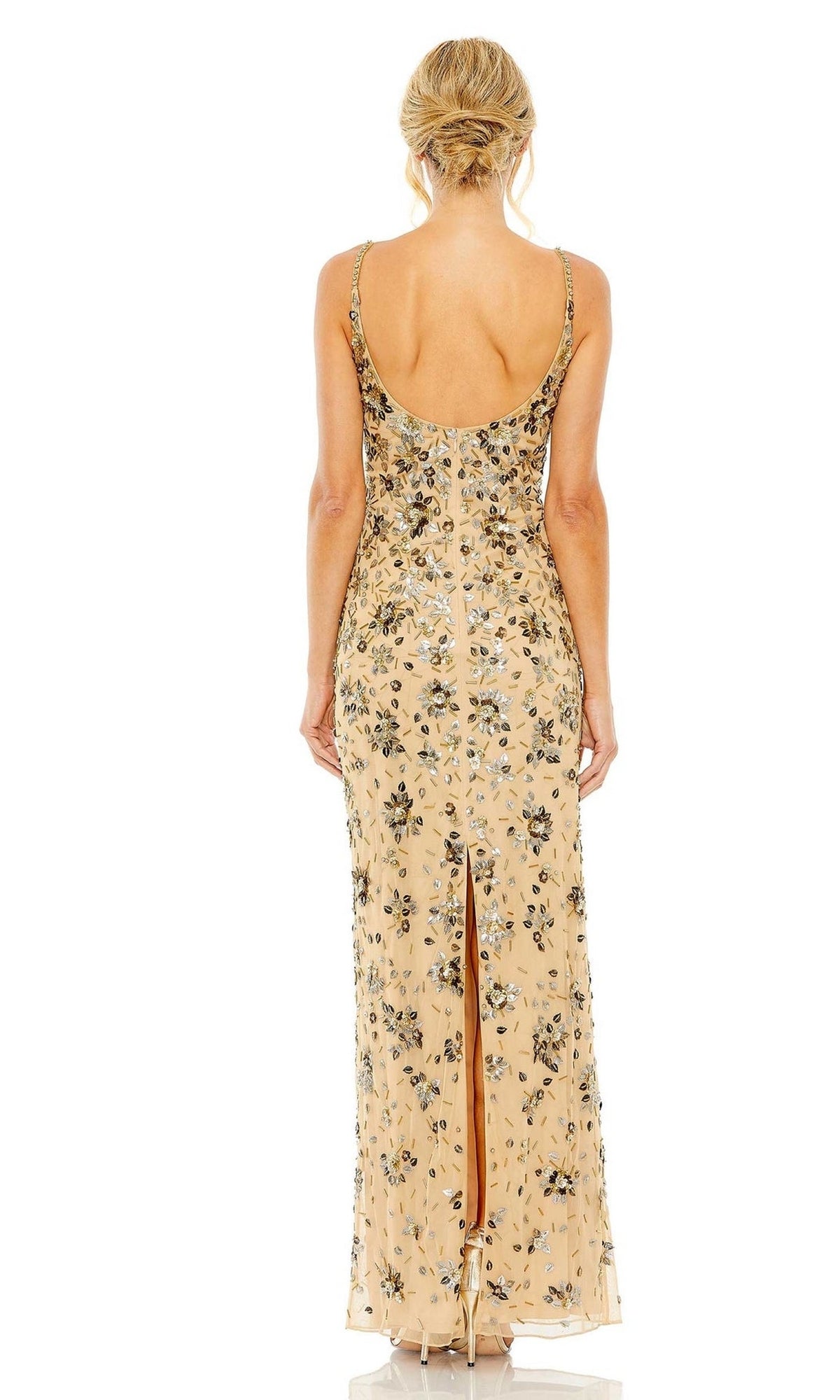 A woman with blonde hair in an updo models the Mac Duggal 5477 Floral-Beaded Long Formal Dress—a sleeveless gold gown with floral beading, low back, and slit—seen from behind against a white background.